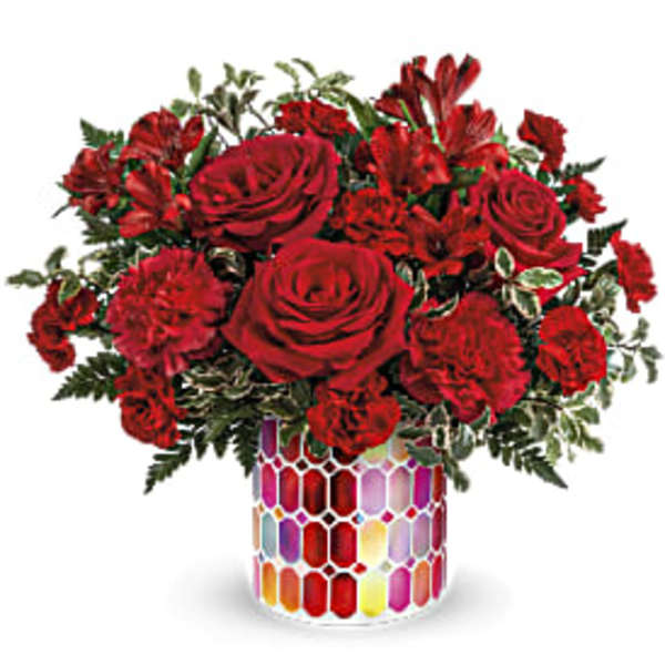 Red roses and carnations in a colorful mosaic vase