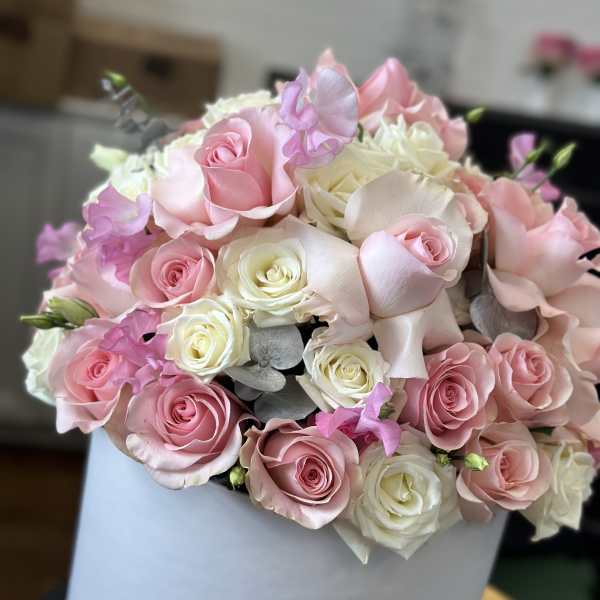 Pink and white rose bouquet in a white hat box