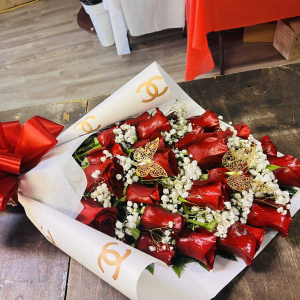 Bouquet of red roses with white baby's breath and a large red bow