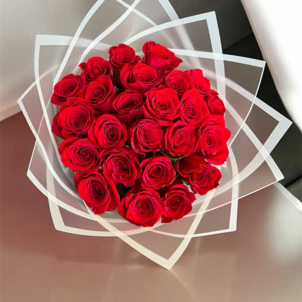 Bouquet of red roses wrapped in clear geometric paper