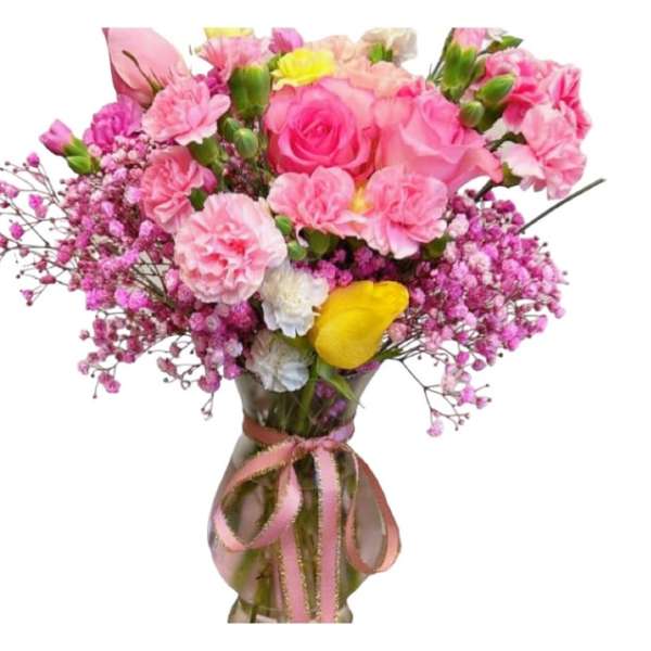 Pink bouquet with roses, carnations, and baby's breath in a glass vase