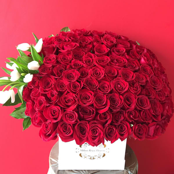 Large bouquet of red roses with white tulips in a white box