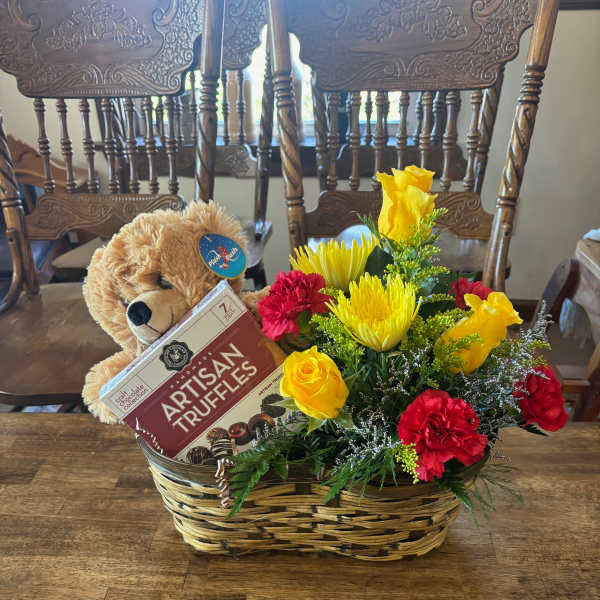 Gift basket with flowers, teddy bear, and chocolate truffles