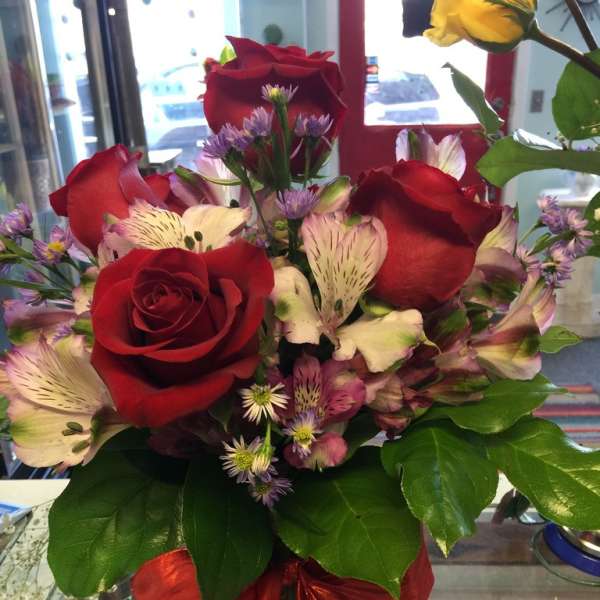 Bouquet of red roses and pink alstroemeria with a red ribbon