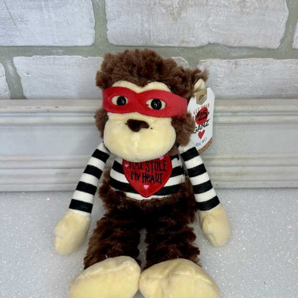 Plush monkey toy with a red mask and striped shirt