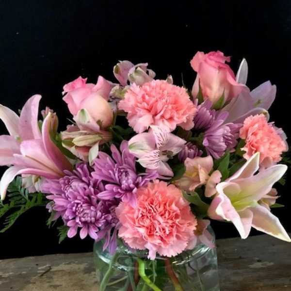 Pink and purple mixed bouquet in a glass vase