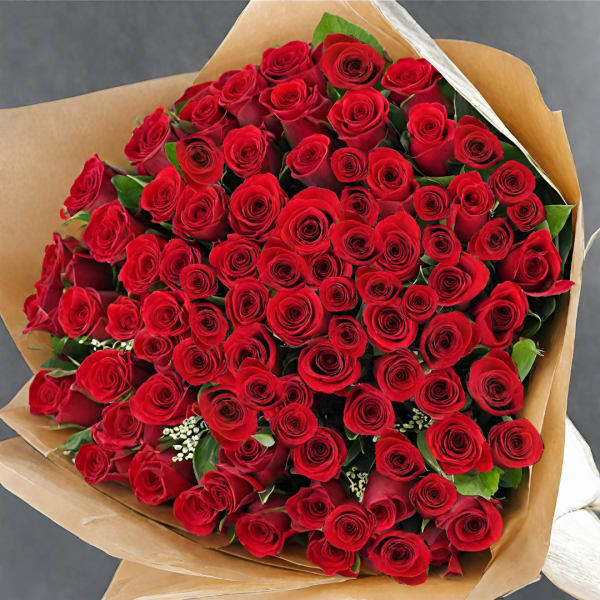 Large bouquet of red roses wrapped in brown paper
