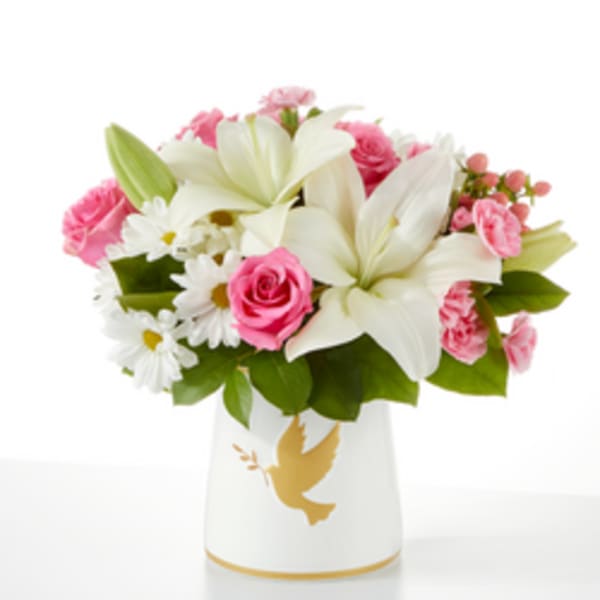 Pink and white flower arrangement in a white vase