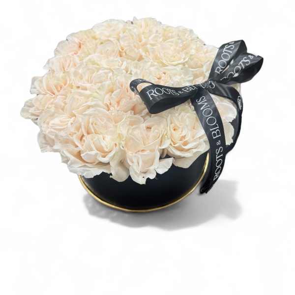 Cream rose bouquet in a black round box with a ribbon bow