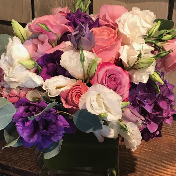 Bouquet of pink, purple, and white flowers in a black box