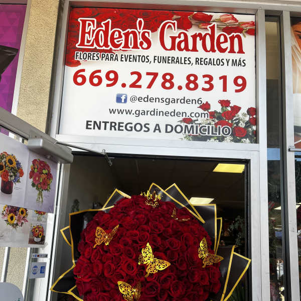 Large red rose bouquet with black and gold wrapping and butterfly accents