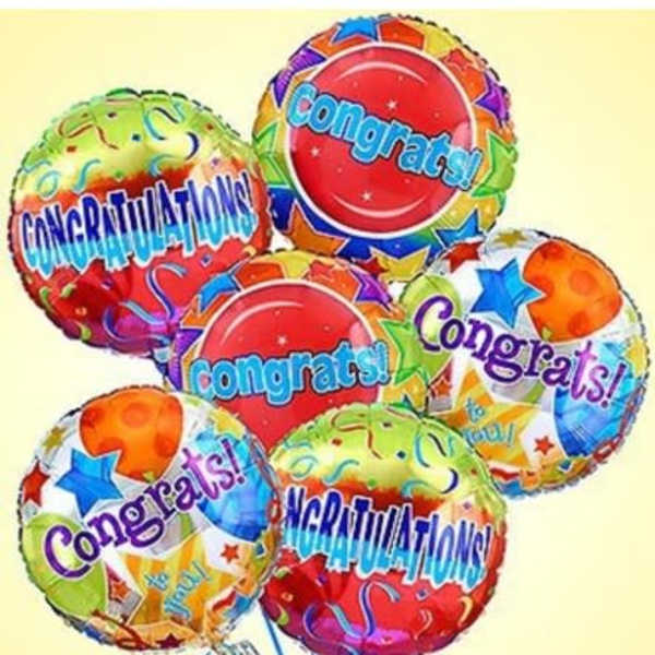 Cluster of colorful congratulatory balloons with star patterns