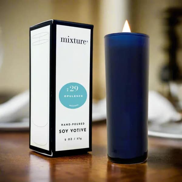 Blue votive candle beside its box on a table