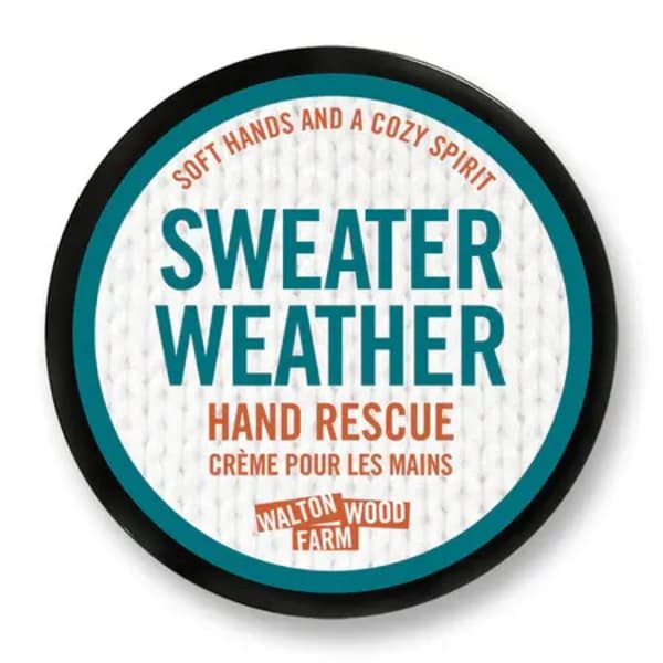 Round tin of hand cream labeled Sweater Weather