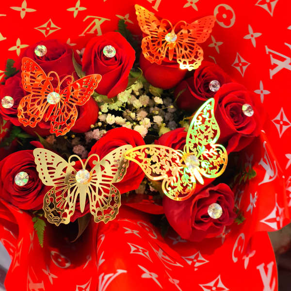 Bouquet of red roses wrapped in bright red patterned paper