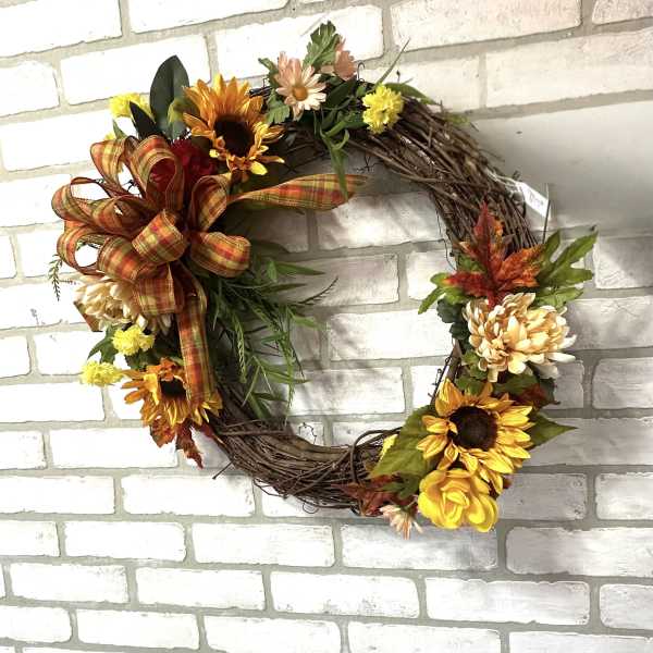 Autumn wreath with sunflowers, daisies, and a plaid bow