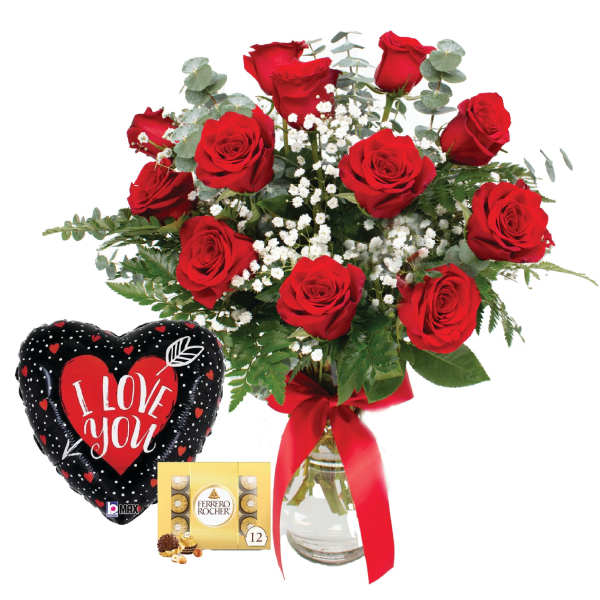 Red roses in a glass vase with a heart balloon and chocolate box