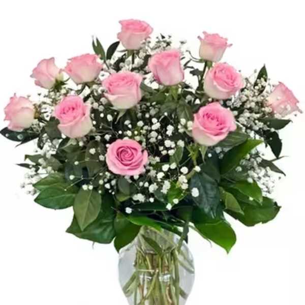 Pink roses and baby's breath in a clear glass vase