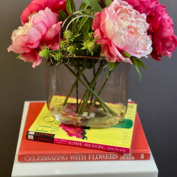Pink peonies arranged in a clear glass vase