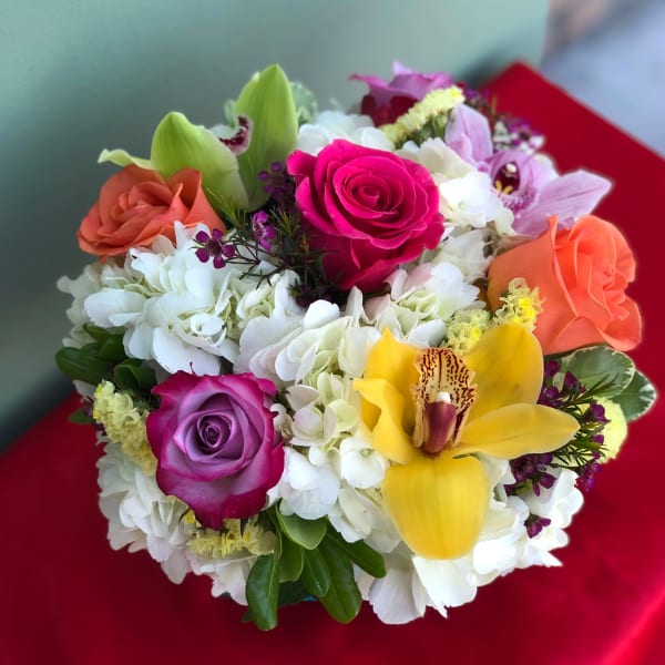 Colorful bouquet with roses, hydrangeas, and a yellow orchid