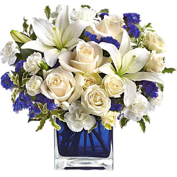 White lilies and cream roses in a blue glass vase