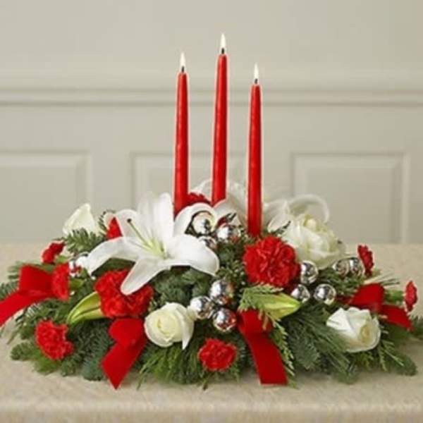 Red and white floral centerpiece with three red candles
