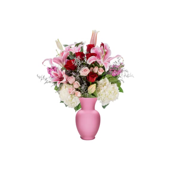 Pink and red flowers arranged in a pink vase