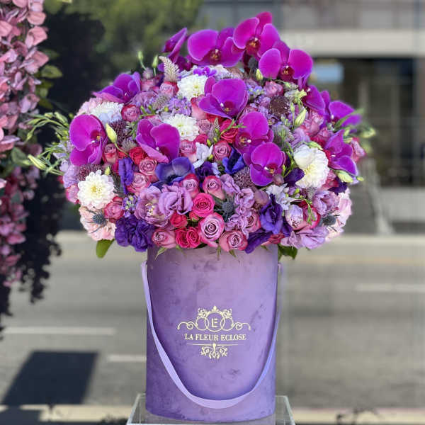 Large purple floral arrangement in a lavender hatbox