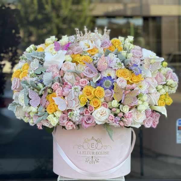 Large pastel rose bouquet in a pink hat box with butterfly accents