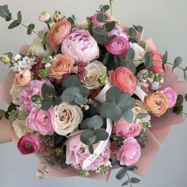 Bouquet of pink and cream flowers with eucalyptus in pink wrap
