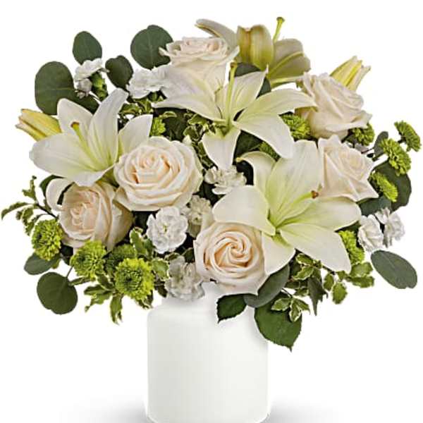 White lilies and cream roses in a white vase