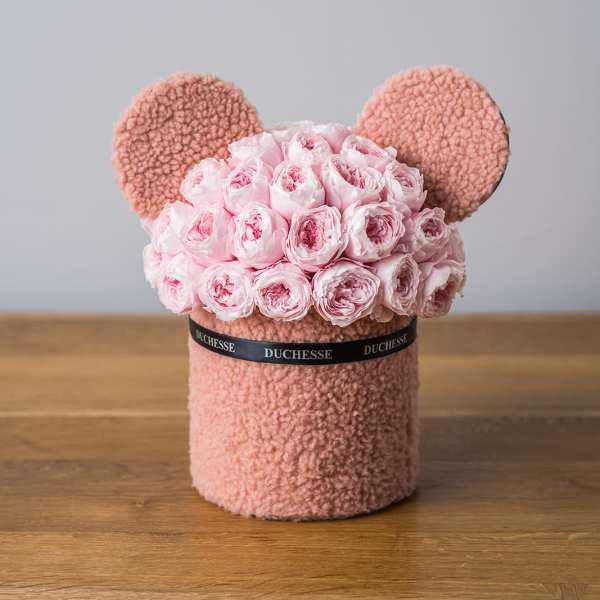 Pink rose bouquet arranged in a teddy bear-shaped box