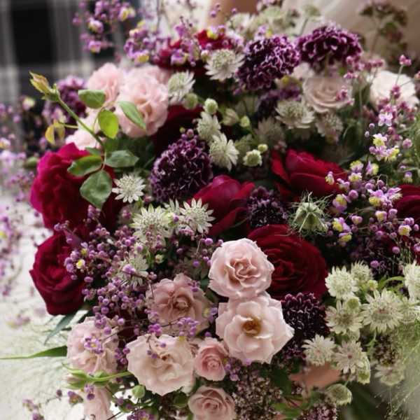 Bouquet of pink and burgundy roses with purple filler flowers