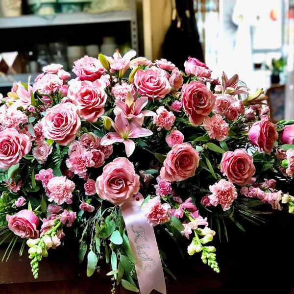 Large pink floral spray with roses, lilies, and carnations