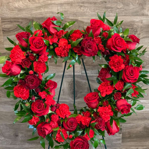 Red rose and carnation wreath on a stand