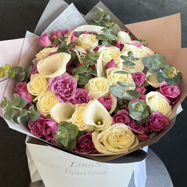 Bouquet of cream and pink roses with white calla lilies