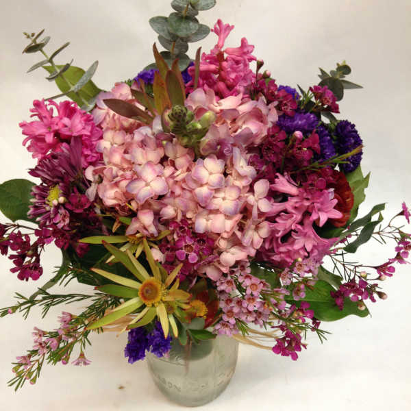 Mixed pink and purple bouquet in a glass vase