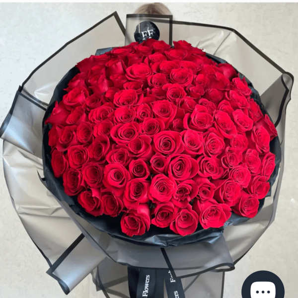 Large bouquet of red roses wrapped in black and gray paper