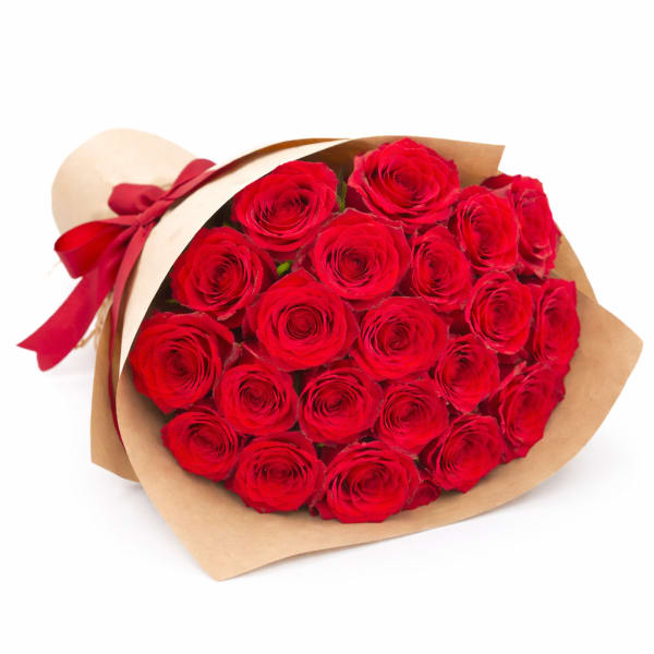 Bouquet of red roses wrapped in brown paper with a red ribbon