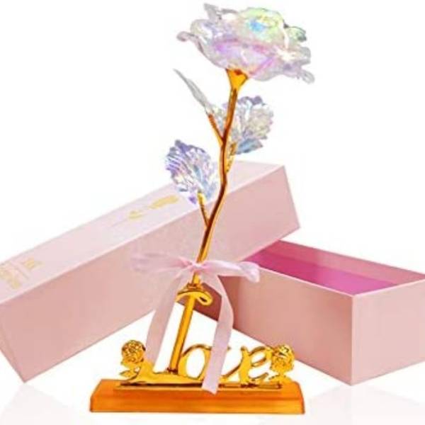 Decorative artificial flower on a gold "love" stand with pink gift boxes