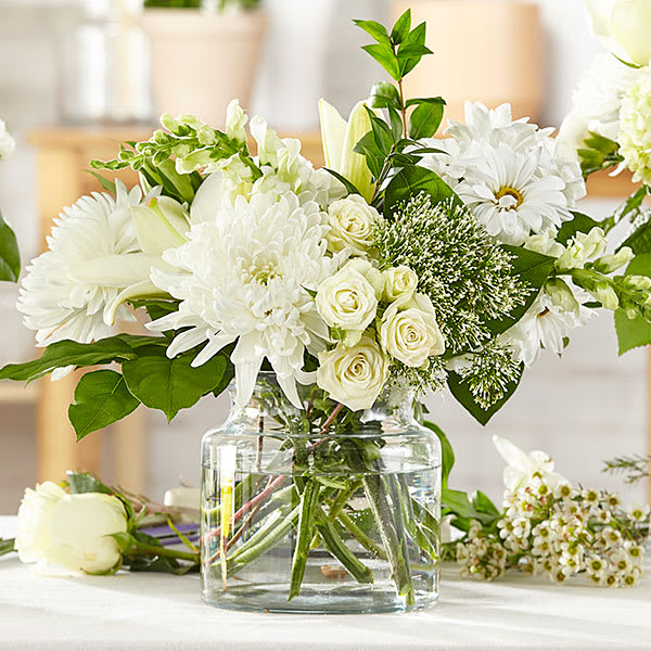 White floral arrangement in a clear glass vase