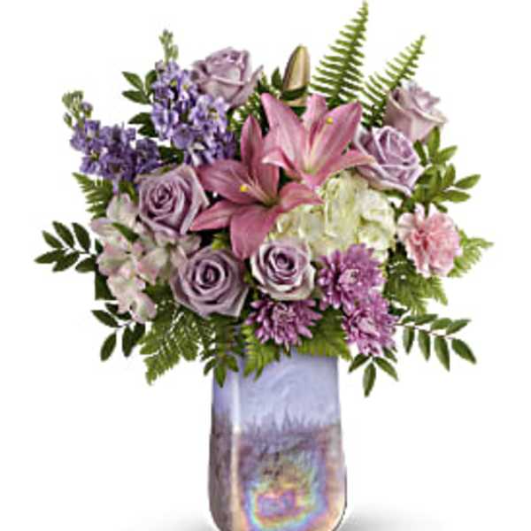 Pink lilies and lavender roses in a tall iridescent vase