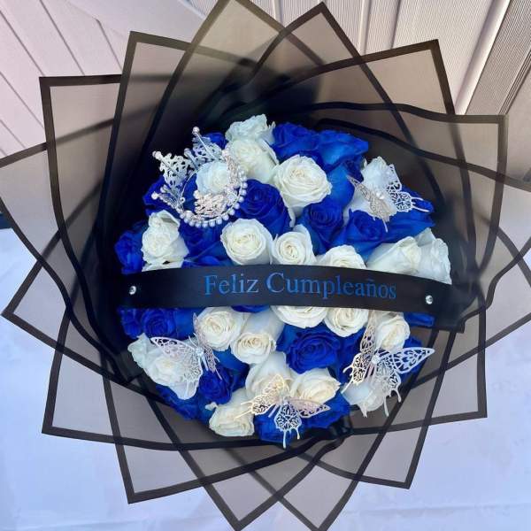 Blue and white rose bouquet wrapped in black paper with butterfly accents