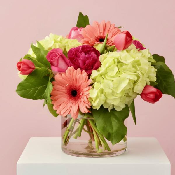 Pink and coral flowers in a clear glass vase