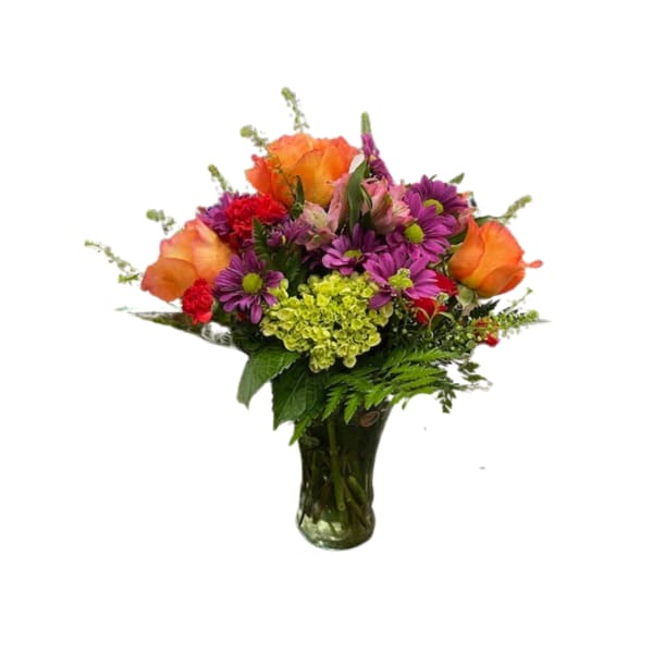 Mixed bouquet of orange roses, purple daisies, and red flowers in a glass vase