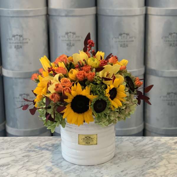 Sunflower and orange rose arrangement in a white hatbox