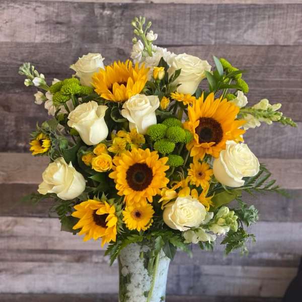 Sunflower and white rose bouquet in a tall vase