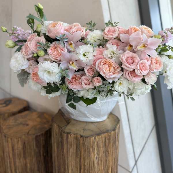 Pink and white floral arrangement in a white vase