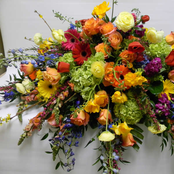 Large colorful floral spray with roses, gerbera daisies, and hydrangeas