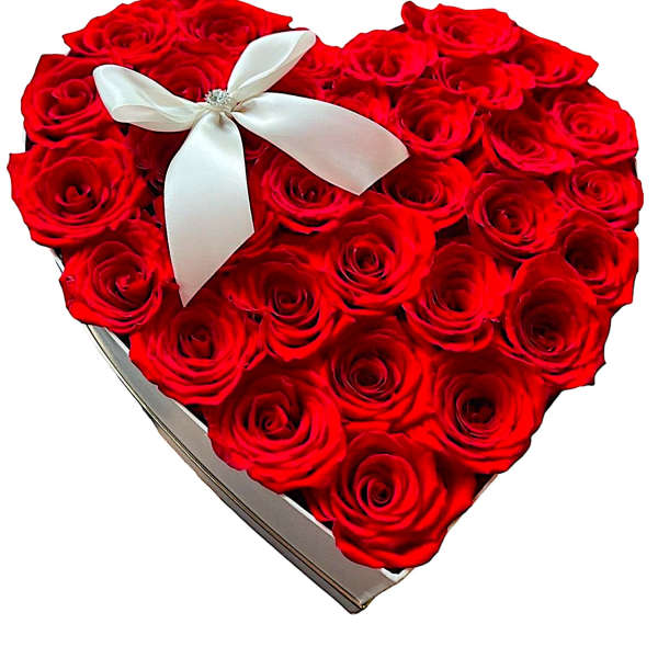 Heart-shaped box filled with red roses and a white ribbon bow